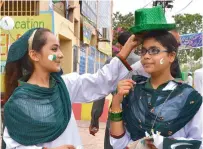  ?? — APP ?? Students purchase caps in the national colour in Multan.