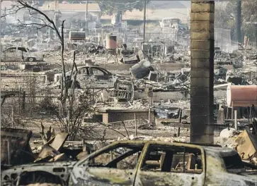  ?? Noah Berger Associated Press ?? HOUSES and vehicles destroyed by the Mill fire line Wakefield Avenue on Sept. 3 in Weed, Calif. Multiple witnesses said the fire appeared to have spread to homes after starting at or near a lumber mill warehouse.