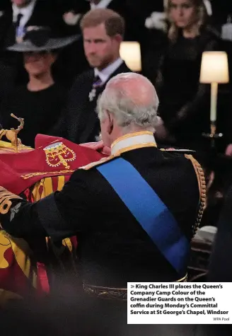  ?? WPA Pool ?? King Charles III places the Queen’s Company Camp Colour of the Grenadier Guards on the Queen’s coffin during Monday’s Committal Service at St George’s Chapel, Windsor