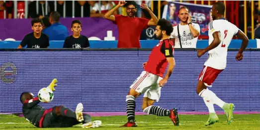  ?? — Reuters ?? Deadly hitman: Egypt’s Mohamed Salah (centre) escapes a Congo Brazzavill­e defender to score his country’s opening goal during the Africa Group E World Cup qualifying match at the Borg El Arab Stadium in Alexandria. Egypt won 2-1.