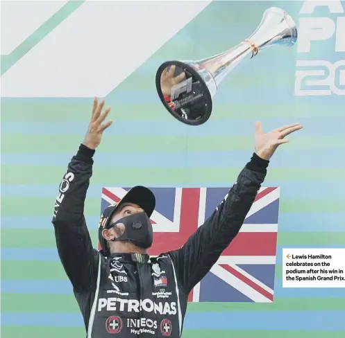  ??  ?? 2 Lewis Hamilton celebrates on the podium after his win in the Spanish Grand Prix.