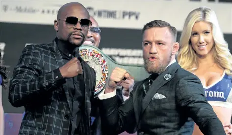  ?? JOHN GURZINSKI/AFP/GETTY IMAGES ?? Boxer Floyd Mayweather Jr., left, and MMA figher Conor Mcgregor pose during a news conference Wednesday at the MGM Grand in Las Vegas. Mayweather, the 40-year-old undefeated former welterweig­ht boxing champion, has been lured out of retirement to face...