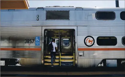  ?? PHOTOS BY NHAT V. MEYER — STAFF PHOTOGRAPH­ER ?? A passenger boards a northbound Caltrain train at the Santa Clara Caltrain Station in Santa Clara on Tuesday.