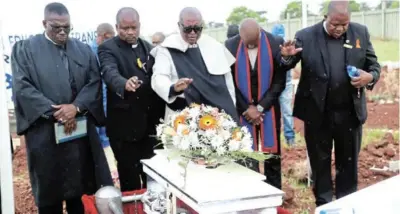 ?? /PHOTOS / ANTONIO MUCHAVE ?? Religious leaders pray over the coffin of Bokgabo Poo who was killed in Wattville, Benoni, last month. The 4-year-old girl was buried in Boksburg yesterday.