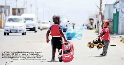  ?? PICTURE: DAVID RITCHIE/AFRICAN NEWS AGENCY/ANA ?? PLAYTIME: Toddlers Isiphilo Nypnyane and Ghamani Sakati play with their toy trucks in Phola Park in Khayelitsh­a. Capetonian­s and visitors to the city have been making the most of sunny weather this week.