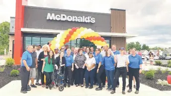  ?? Of Mary Powers — Courtesy ?? Philiou with his family and several employees at his McDonald’s restaurant in Mayfield Heights, Ohio. When he closed the restaurant for three months amid renovation­s, he continued to pay all 90 employees their regular wages.