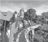  ??  ?? The Casey Jr. Circus Train heads over the trestle at Disneyland.