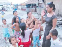  ??  ?? Main portrait: Anna McDougall and the Corvina, which is being prepared for an aid mission to the Philippine­s, and above in Tacloban four years ago.