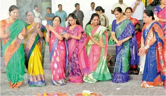  ??  ?? Chief Minister K. Chandrasek­har Rao’s wife Shobha (third from left), TRS MP K. Kavitha (centre) and Governor E.S.L. Narasimhan’s wife Vimala (second from right) take part in a Bathukamma dance at the Chief Minister’s residence in Hyderabad on Saturday.