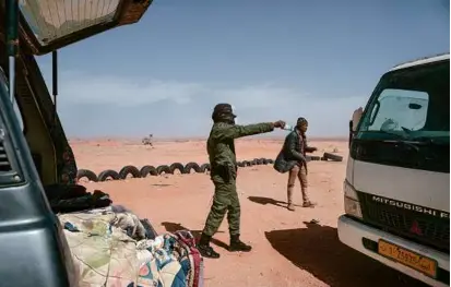  ?? CARMEN ABD ALI/NEW YORK TIMES ?? Soldiers checked vehicles returning from Libya on the road out of Agadez, Niger, last month.