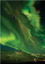  ??  ?? Below: Aurora over Iceland in 2012 after a CME. As charged particles from the Sun collide with our atmosphere, different colors are generated—green for collisions with oxygen, and red for nitrogen.