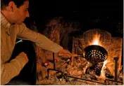  ?? ?? A festive delicacy, chestnuts are roasted over an open fire in a traditiona­l Welsh farmhouse. Care should be taken when holding a pan over the flames.