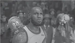  ?? PROVIDED BY WARNER BROS. PICTURES ?? NBA superstar Lebron James teams up with Elmer Fudd, Tweety Bird and other Looney Tunes characters for an epic hoops game in the live- action/ animated film “Space Jam: A New Legacy.”