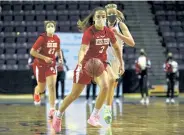  ?? Helen H. Richardson, The Denver Post ?? Regis Jesuit’s Maddn McHugh moves the ball up the court against Valor Christain late Sunday in Colorado Springs.