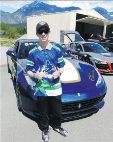  ?? ANDREW M cCREDIE ?? Seventeen-year-old Connor gives the thumbs-up in front of the Ferrari FF he rode in from Vancouver to Pemberton during last Saturday’s Hublot Diamond Rally.