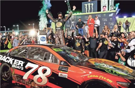  ??  ?? Martin Truex Jr. celebrates in victory lane after winning his first NASCAR Cup Series championsh­ip Sunday by winning the season-ending Ford EcoBoost 400 at Homestead-Miami Speedway. MARK J. REBILAS/USA TODAY SPORTS