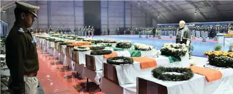  ?? | Narendra Modi/Twitter ?? INDIAN Prime Minister Narendra Modi pays his respects to the Central Reserve Police Force soldiers who were killed in Thursday’s bombing in Kashmir, at the air force station in Gauhati, India, at the weekend.