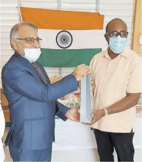  ??  ?? Chairman of Hillside Primary School in Islington, St Mary, and director of Ashish group Milton Gager, JP (right), receives a package on behalf of the institutio­n from Second Secretary of the High Commission of India, kingston Jamaica, Girish Juneja at the school on Friday.