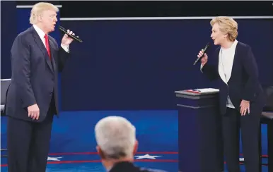  ?? (Jim Young/Reuters) ?? REPUBLICAN PRESIDENTI­AL nominee Donald Trump and Democratic nominee Hillary Clinton take part in a town-hall debate at Washington University in St. Louis on Sunday.