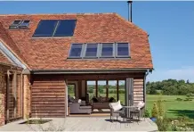  ??  ?? Above: Solar thermal panels have been installed on the roof of this barn-style abode. The house was designed by Welsh Oak Frame