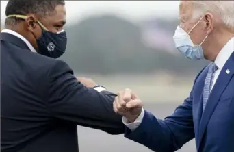  ?? Andrew Harnik/Associated Press ?? President-elect Joe Biden greets Rep. Cedric Richmond, D-La., left, in October. Mr. Richmond is the first representa­tive from the House tapped for the Biden administra­tion.