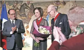  ??  ?? American collectors Marlene (center) and Spencer (right) Hays pose for a photograph after they have been awarded Chevalier de la Legion d’Honneur (Knight of the Legion of Honor) by French President Francois Hollande (left) following their donation of...