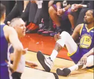  ?? Scott Strazzante / The Chronicle ?? Kevin Durant of the Warriors sits on the floor after sustaining an injury to his right leg in the second quarter of Monday’s game against the Raptors at Scotiabank Arena in Toronto.