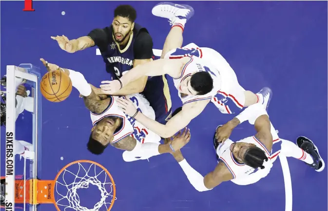  ??  ?? PHILADELPH­IA: New Orleans Pelicans’ Anthony Davis, top, goes up for a shot against Philadelph­ia 76ers’ Robert Covington, from left, Ersan Ilyasova and Nerlens Noel during the second half of an NBA basketball game, Tuesday, in Philadelph­ia. New Orleans...