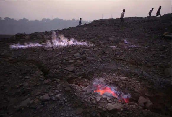  ?? Getty ?? Flames rise from an undergroun­d coal seam fire in Bokapahari, India. About three quarters of the country’s electricit­y comes from coal-powered plants