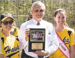  ??  ?? Softball co-captains Corrine Fernald of Mechanicsv­ille, left, and Diana Cruz of Lexington Park, right, present a plaque expressing the team’s gratitude to CSM President Dr. Brad Gottfried for his support to upgrade the field and create dugouts for the...