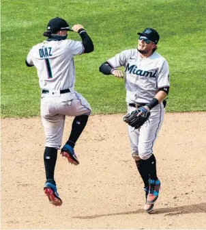  ?? CHRIS SZAGOLA/AP ?? Miguel Rojas, right, celebrates with Isan Diaz after the Marlins’ 11-6 win over the Phillies on Sunday.