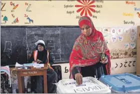  ?? Photo: Patrick Meinhardt/afp ?? Casting her ballot: A woman votes at a polling station in Stone Town, Zanzibar, on Wednesday.