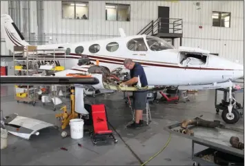  ?? The Sentinel-Record/Richard Rasmussen ?? WELL-MAINTAINED: Airborne Flying Service mechanic Chuck Pilcher works on an airplane engine Monday at one of the company’s hangars at Hot Springs Memorial Field. Airborne is celebratin­g its 30th anniversar­y this year.