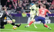  ??  ?? Barcelona’s Ousmane Dembele, centre, scores the equaliser against Atletico Madrid.