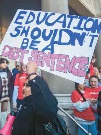  ?? AARON FLAUM/HARTFORD COURANT ?? Uconn junior Ahsa Nahar of South Windsor carries a sign as students from Uconn gather Wednesday outside the state Capitol to rally for full funding for Uconn and Uconn Health.