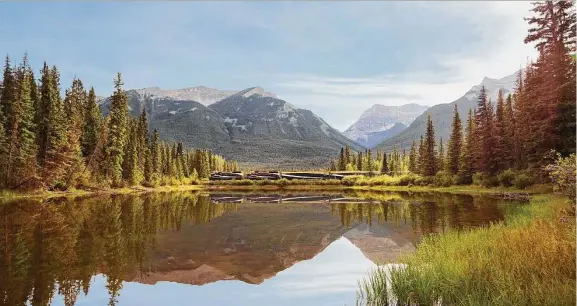  ?? Rocky Mountainee­r ?? A Rocky Mountainee­r train passes Mule Shoe Lake in Alberta, Canada, on the First Passage to the West route.