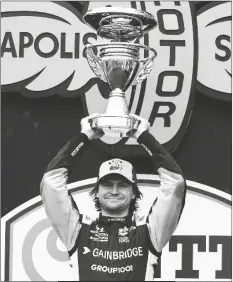  ?? DARRON CUMMINGS/AP ?? COLTON HERTA holds the trophy after winning the IndyCar Grand Prix auto race at Indianapol­is Motor Speedway on Saturday in Indianapol­is.