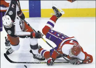  ?? Nick Wass The Associated Press ?? Blue Jackets defenseman Seth Jones (3) and Capitals right wing T.J. Oshie joust for the puck in the third period of Columbus’ 2-1 OT win Saturday.