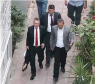  ??  ?? Brunson (wearing a red tie) is escorted home in Izmir yesterday after being freed following a trial in a court in Aliaga, western Izmir province.