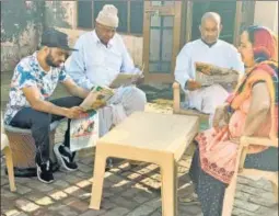  ?? HT ?? Amit Panghal (L) with family members at his home in Myna, near Rohtak in Haryana.