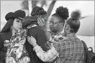  ?? MICHAEL WYKE/AP FILE PHOTO ?? Darryl George, center left, a 18-year-old junior, and his mother Darresha George, center right, share words of encouragem­ent before walking across the street to go into Barbers Hill High School after Darryl served a 5-day in-school suspension for not cutting his hair in September in Mont Belvieu, Texas.