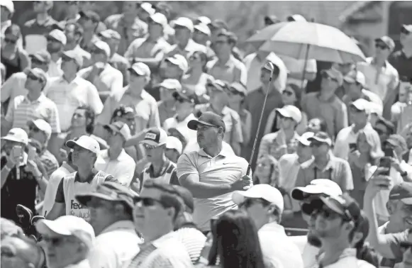  ?? BRAD VEST/THE COMMERCIAL APPEAL ?? Fans gather around Brooks Koepka at No. 14 during the WGC-FEDEX St. Jude Invitation­al at TPC Southwind last year.