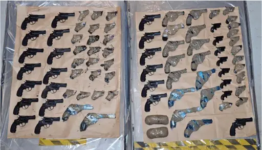  ??  ?? Lethal haul: The 6mm and 4mm guns, many of which had been taped up to remove previous users’ fingerprin­ts