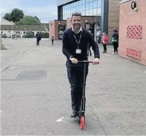  ??  ?? Fun for all Head teacher Graham Donnachie is also delighted with the new scooters