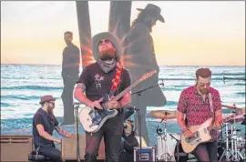  ??  ?? BROTHERS OSBORNE imports the ocean to the desert — check out that backdrop — during their set Saturday at Stagecoach, which included salute to Yoakam.