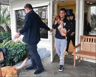  ?? CHELSEA TODARO / PALM BEACH POST ?? Zachary Cruz, the 18-yearold brother of Parkland shooter Nikolas Cruz, leaves VCA Simmons Animal Hospital in Greenacres with his two dogs. Zachary plans to move from Palm Beach County to Virginia, a move allowed by a judge Friday.