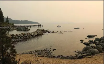  ?? ?? A thick layer of smoke is seen hanging over Lake Tahoe on Sept. 3 as a result of the still-burning Caldor Fire.