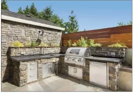  ??  ?? Outdoor kitchens are trending, with many people customizin­g patio spaces with a grill, hearth or pizza oven, a refrigerat­or and even a sink.