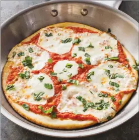  ?? The Associated Press ?? This recipe for skillet pizza appears in the cookbook Bread Illustrate­d.