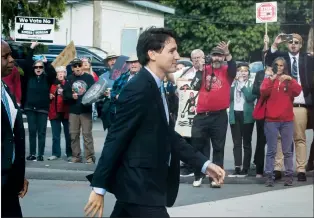  ?? CP PHOTO DARRYL DYCK ?? Protesters opposed to the Kinder Morgan Trans Mountain pipeline expansion shout at Prime Minister Justin Trudeau as he arrives for a discussion with the Indigenous Advisory and Monitoring Committee, on the Cheam First Nation near Chilliwack, B.C., on...